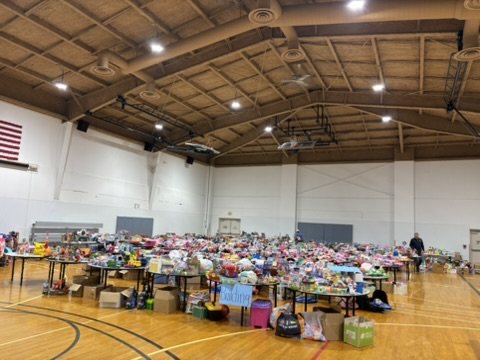 A church gym filled with tables of donated toys before the doors open