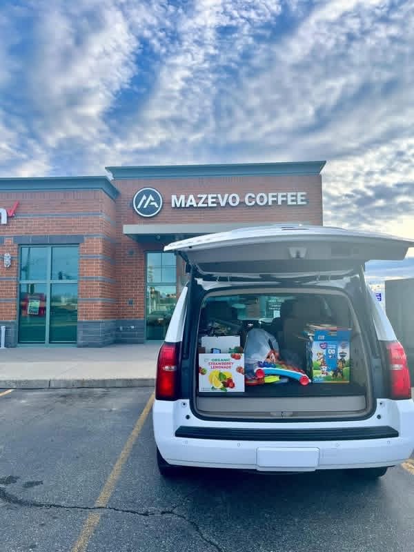 A car full of donated toys parked outside Mazevo Coffee