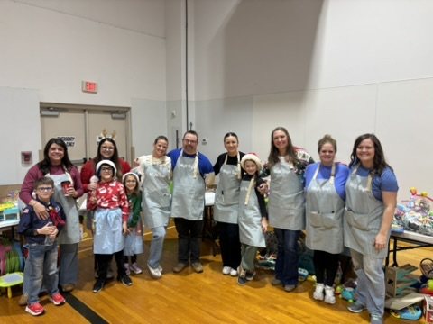 A group of Misfit Toys volunteers in aprons